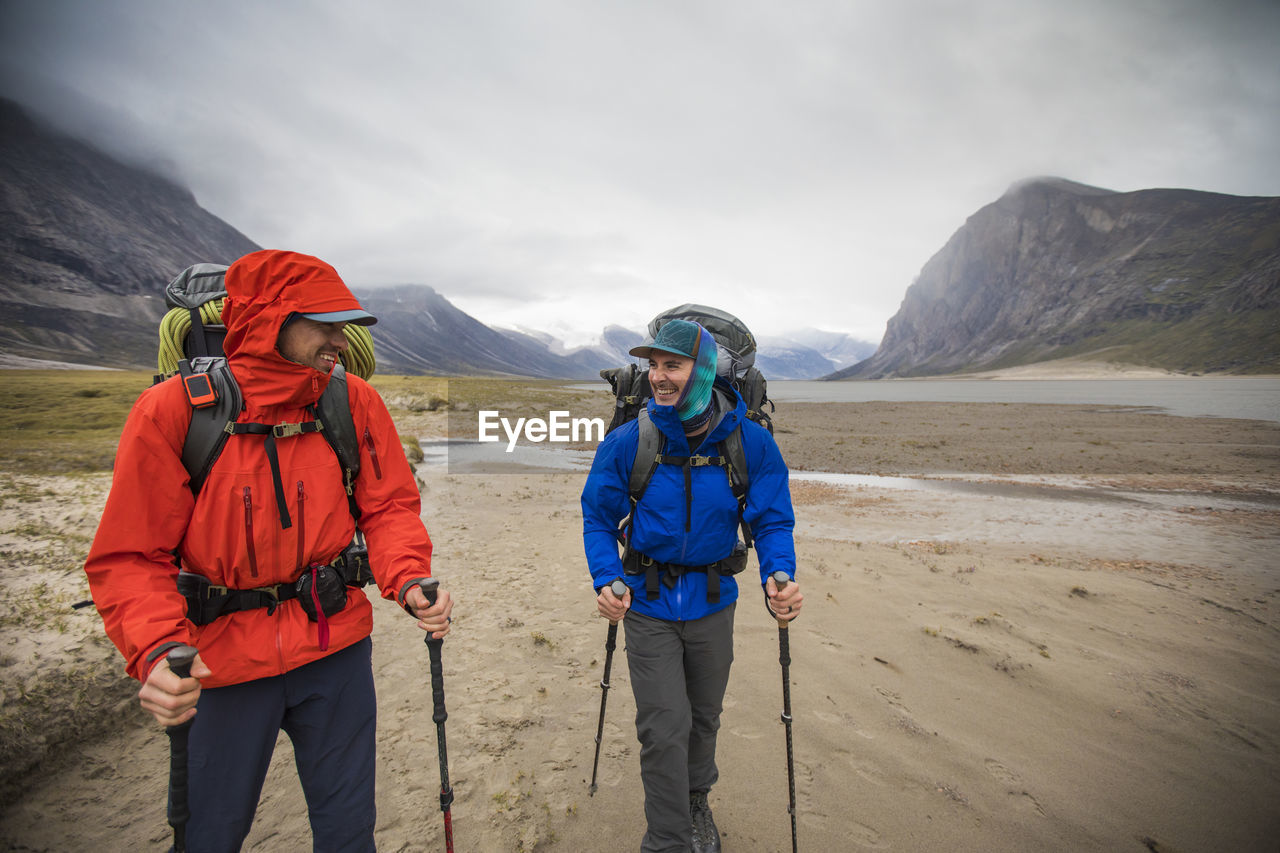 Two backpackers enjoy hiking in remote location, baffin island.