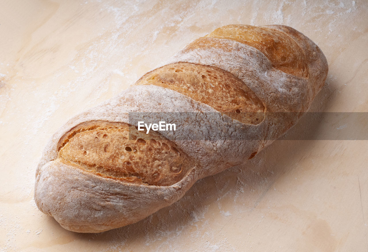 bread, food and drink, food, baked, loaf of bread, rye bread, freshness, healthy eating, wellbeing, baguette, flour, indoors, sourdough, ciabatta, no people, close-up, bakery, store, wood, table, still life, whole grain, brown, french food, wheat, high angle view, brown bread, whole wheat