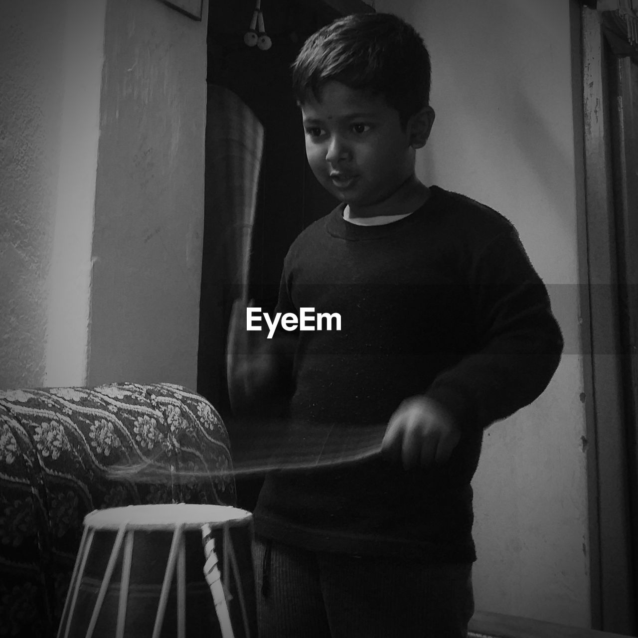 Portrait of boy standing at home