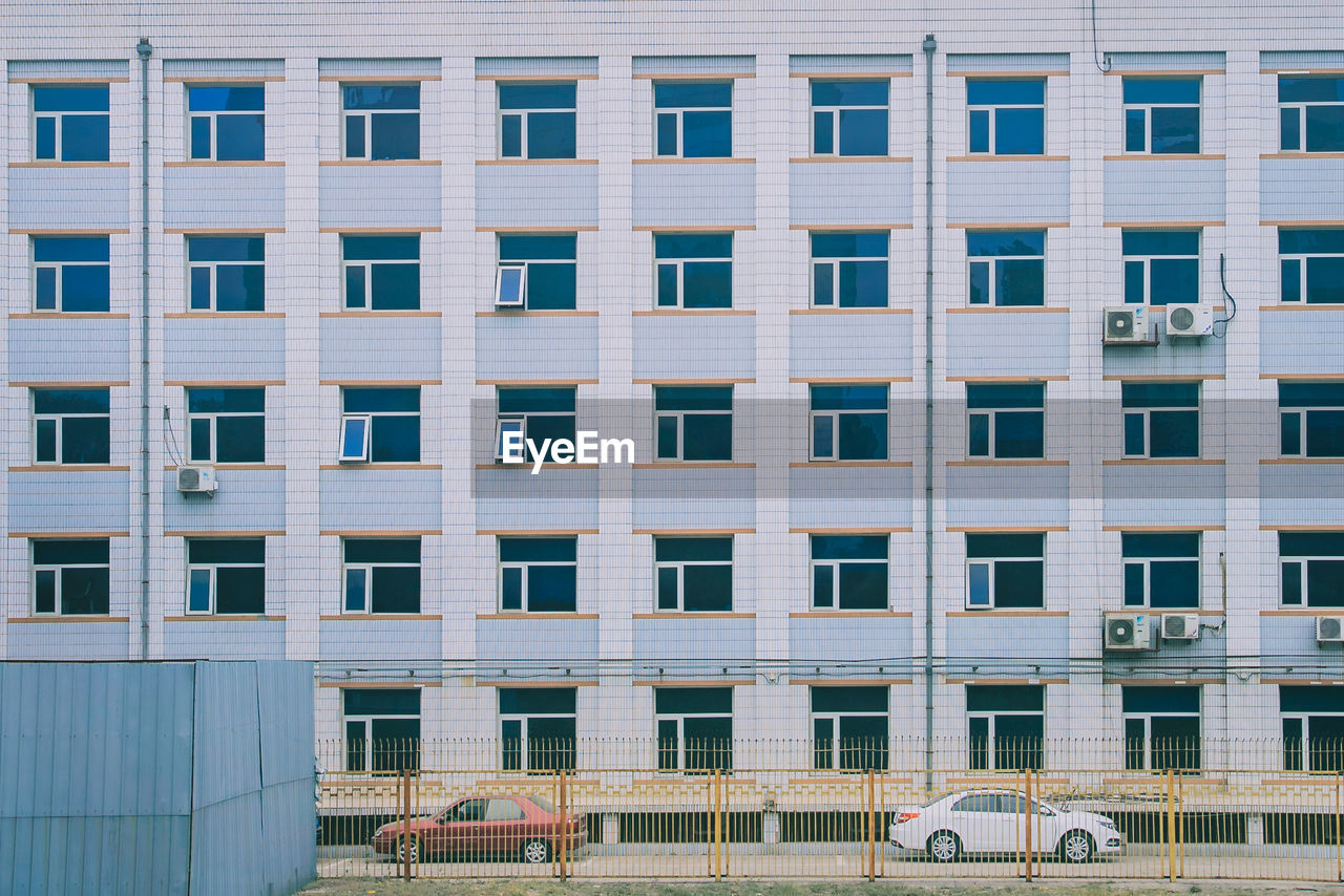 Cars on road against building