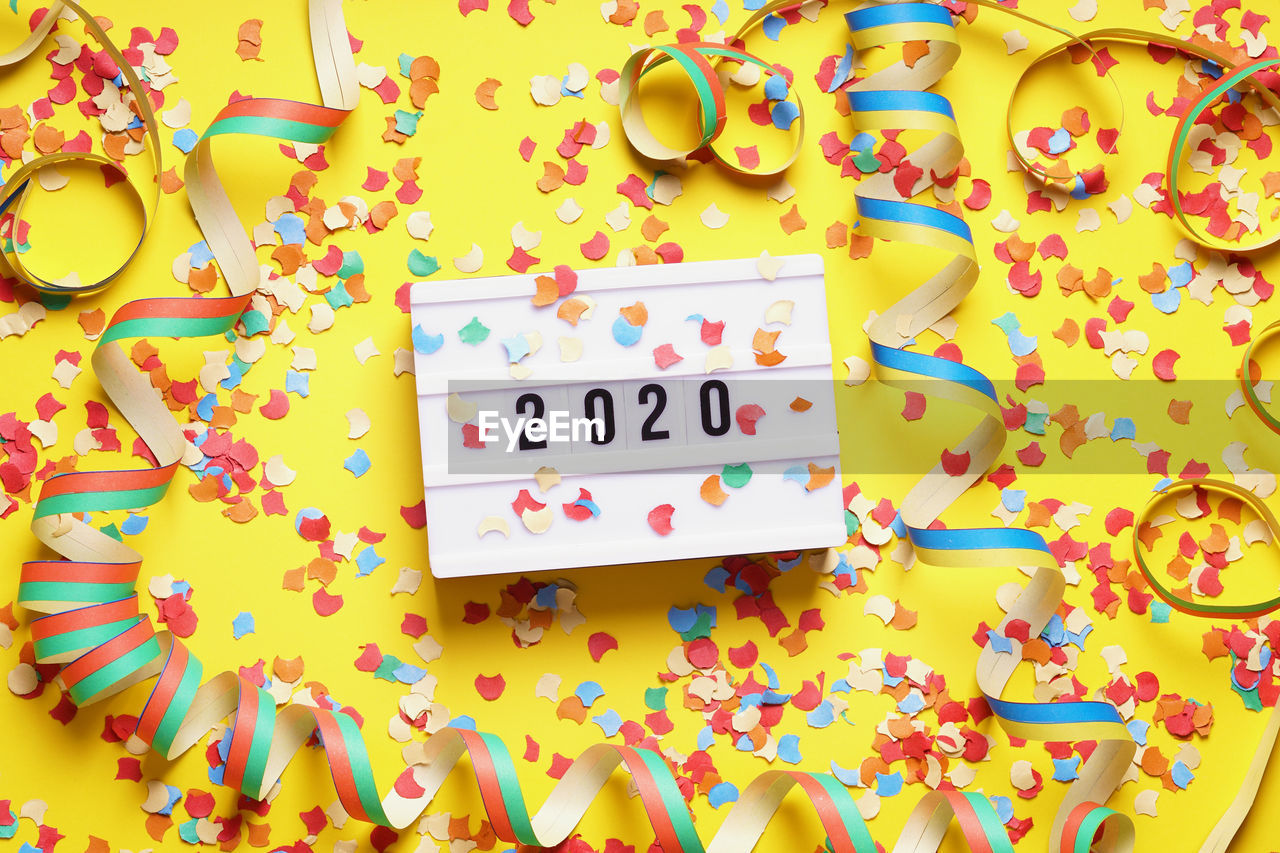 Multi colored confetti and number 2020 on table