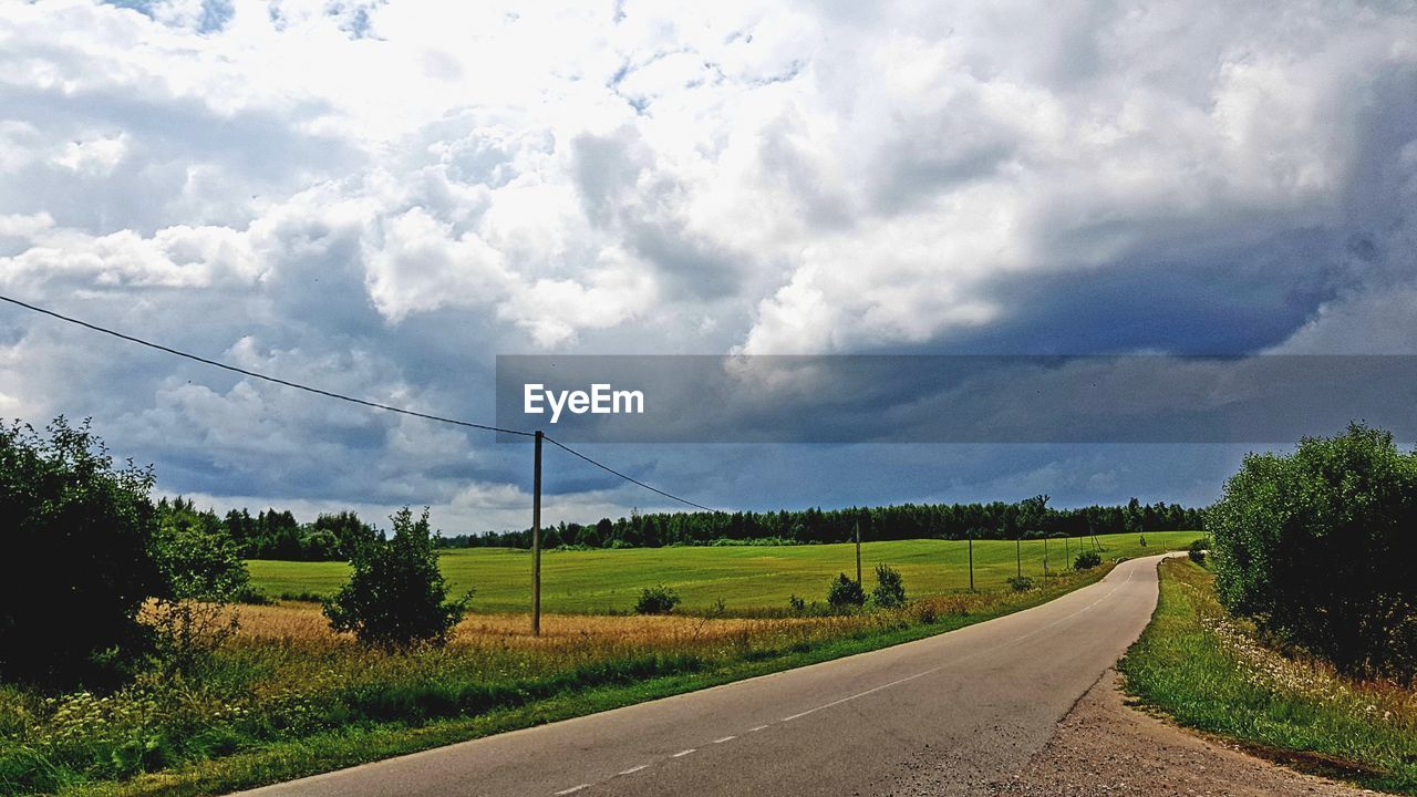 EMPTY COUNTRY ROAD ALONG LANDSCAPE