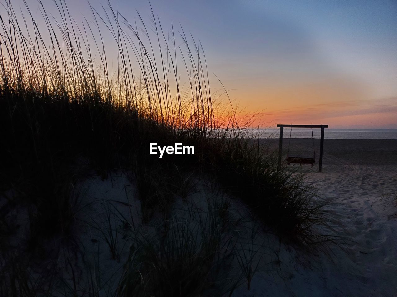 SCENIC VIEW OF BEACH DURING SUNSET