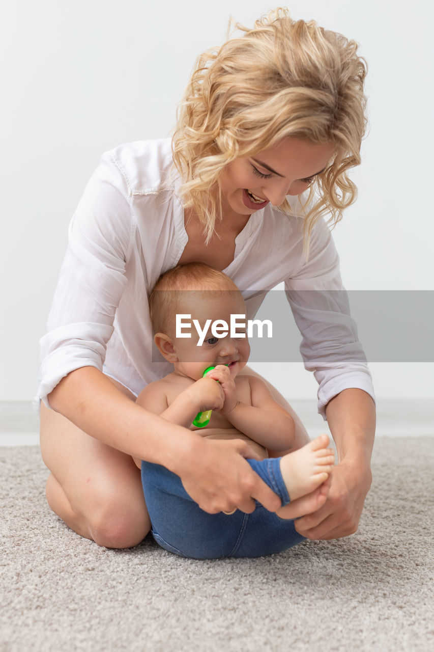 Mother playing with daughter at home