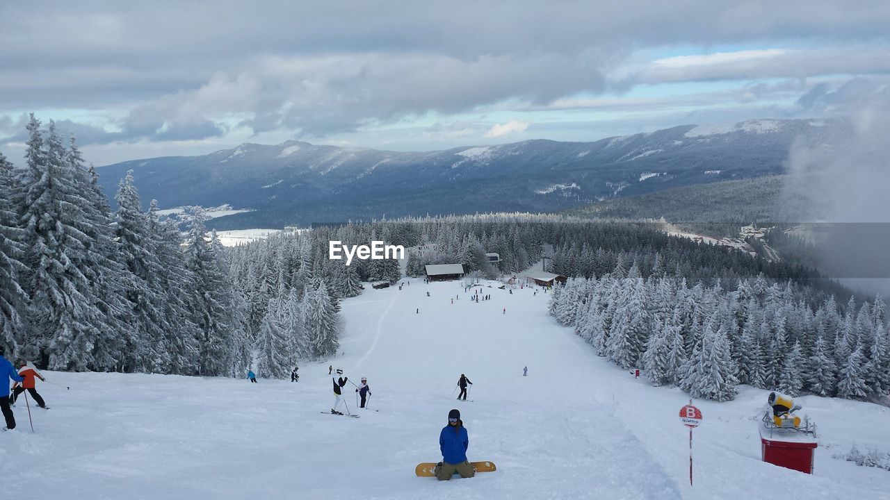 People skiing on mountain slope