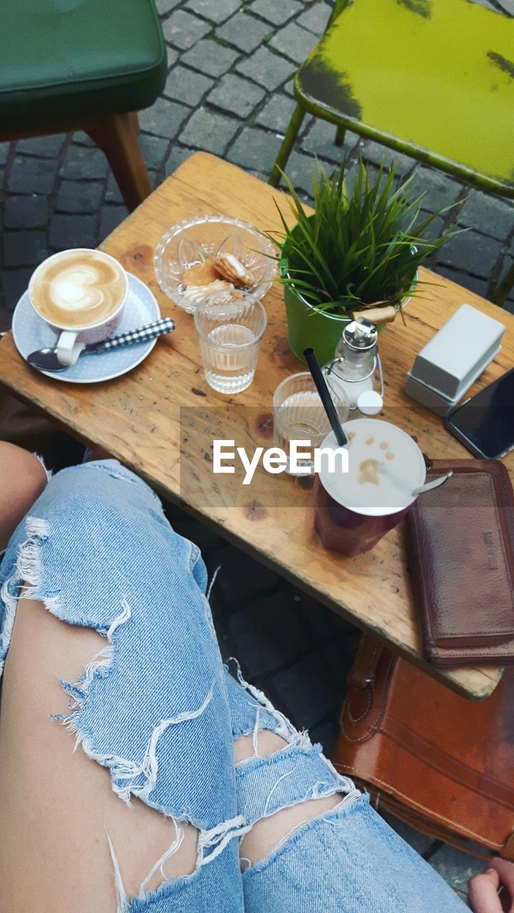 HIGH ANGLE VIEW OF COFFEE ON TABLE AT CAFE