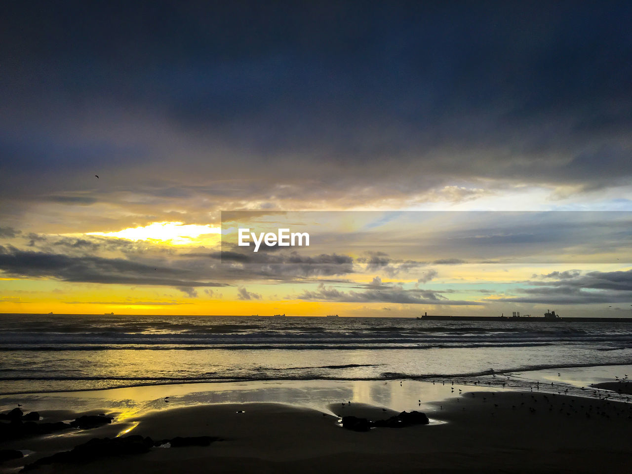 Scenic view of dramatic sky over sea during sunset