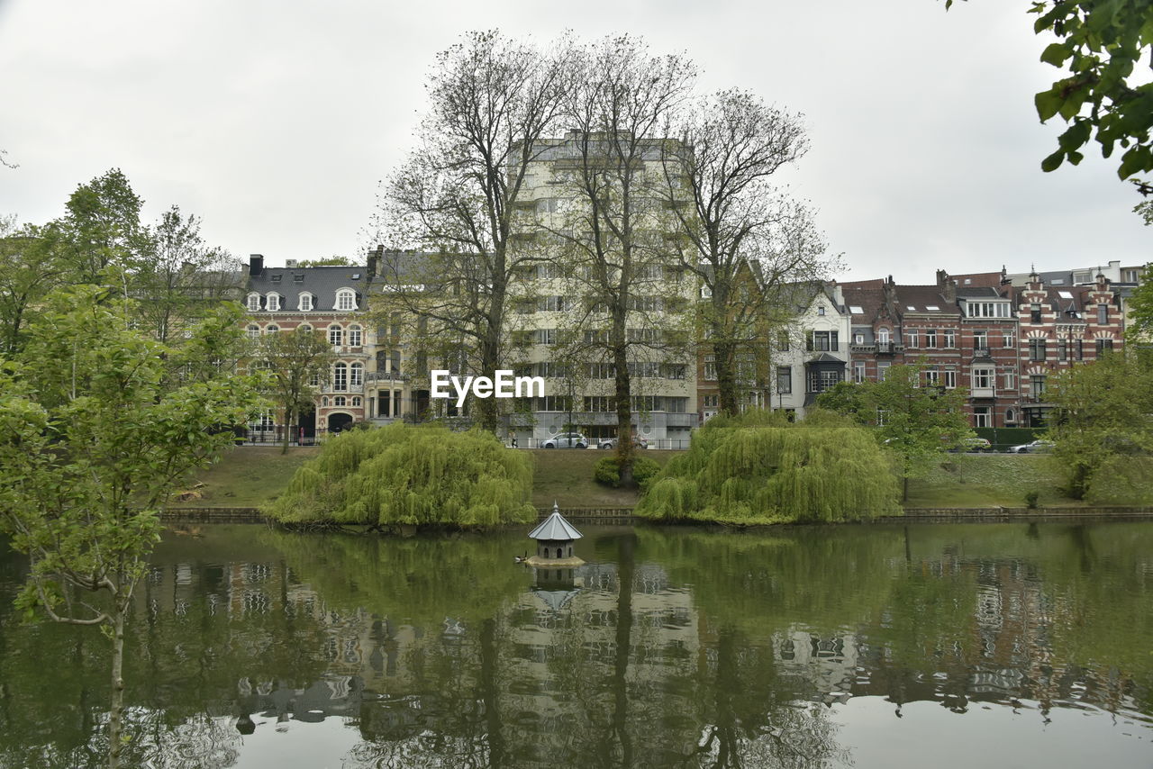 Reflection of trees and buildings in lake