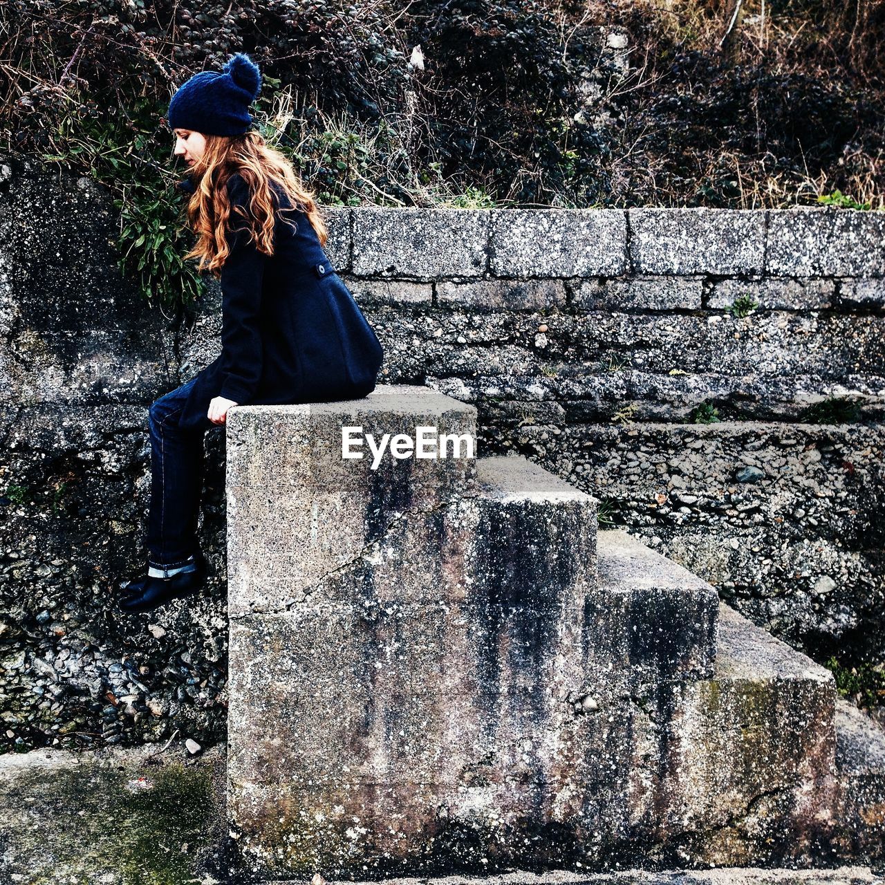 YOUNG WOMAN STANDING ON GROUND