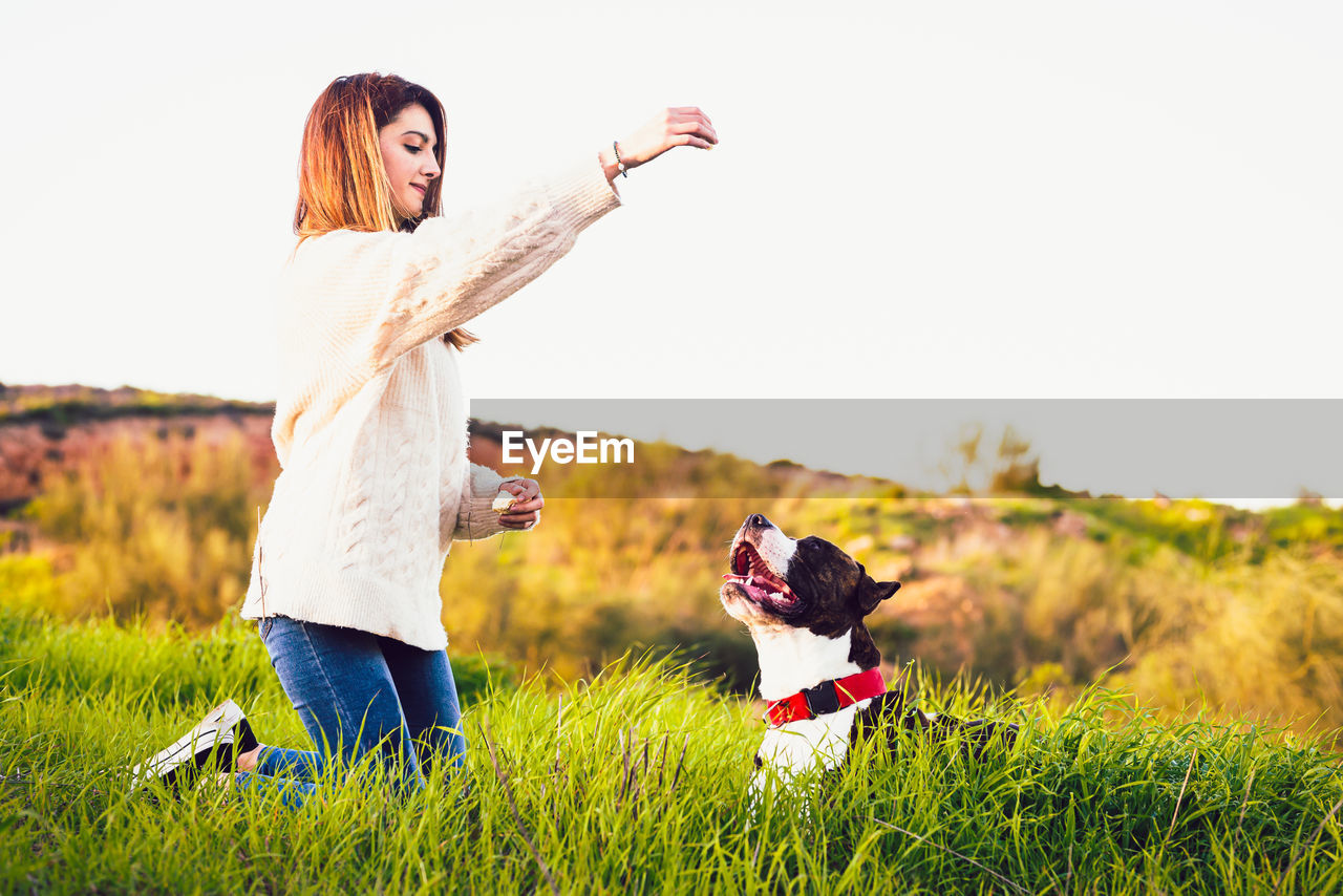 Woman with dog on field