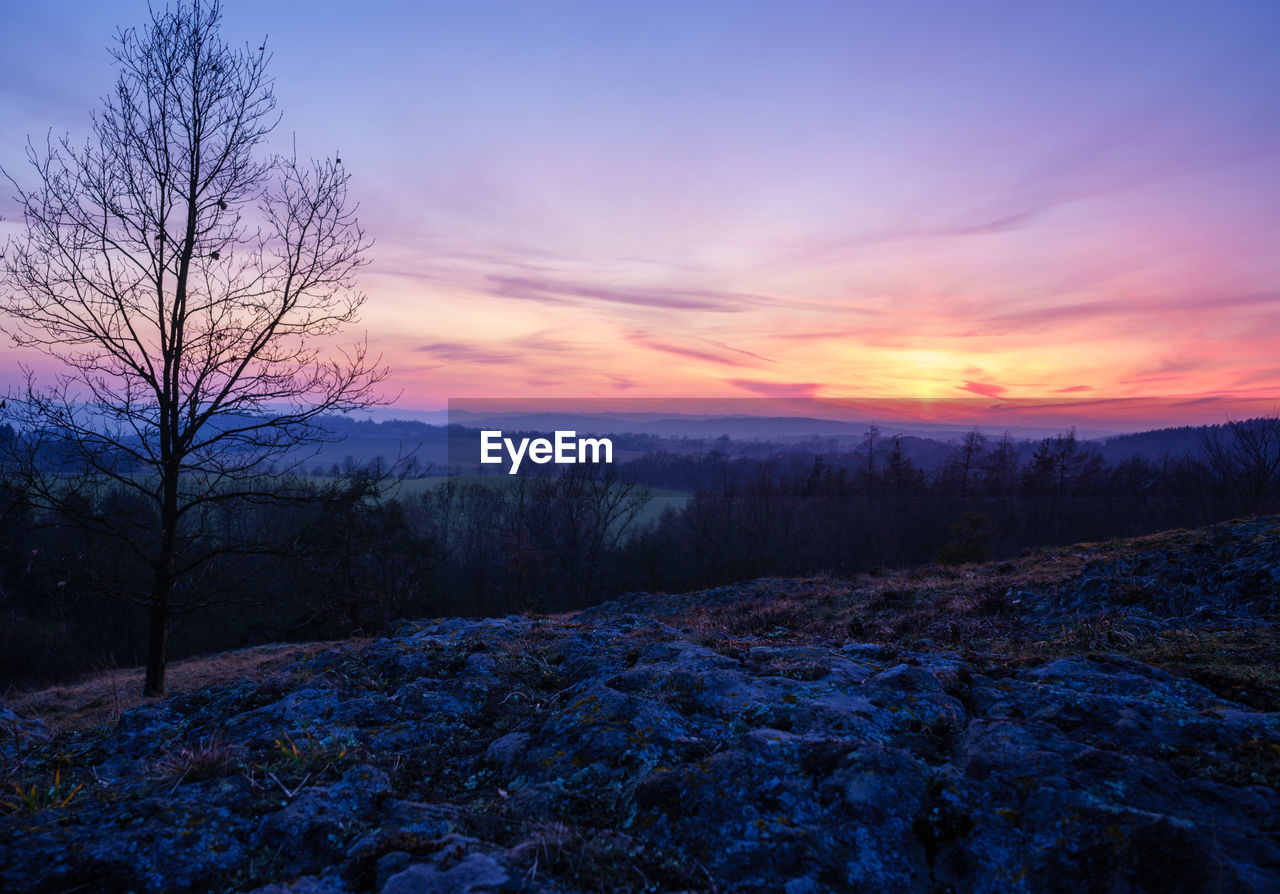 Scenic view of snow covered landscape at sunset