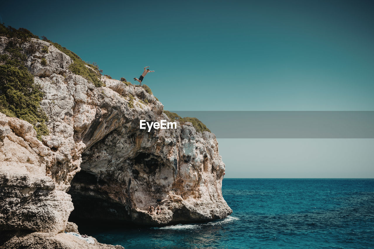 ROCK FORMATIONS BY SEA AGAINST SKY