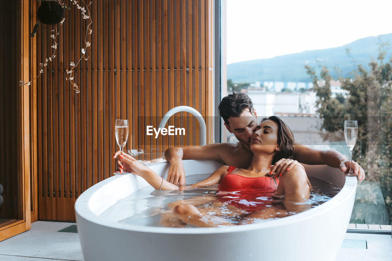 Young couple relaxing in bathtub