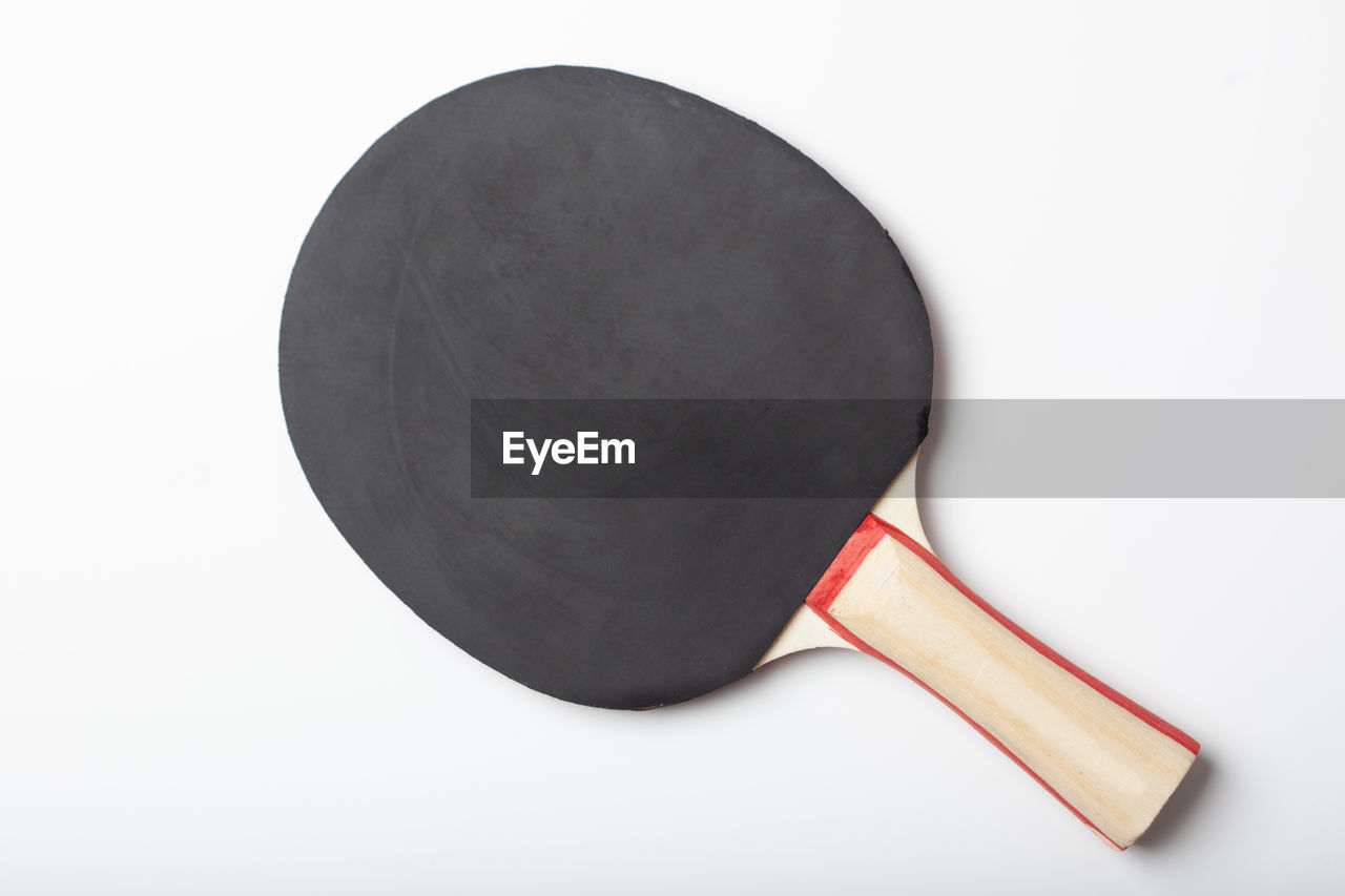 Close-up of table tennis bat on white background