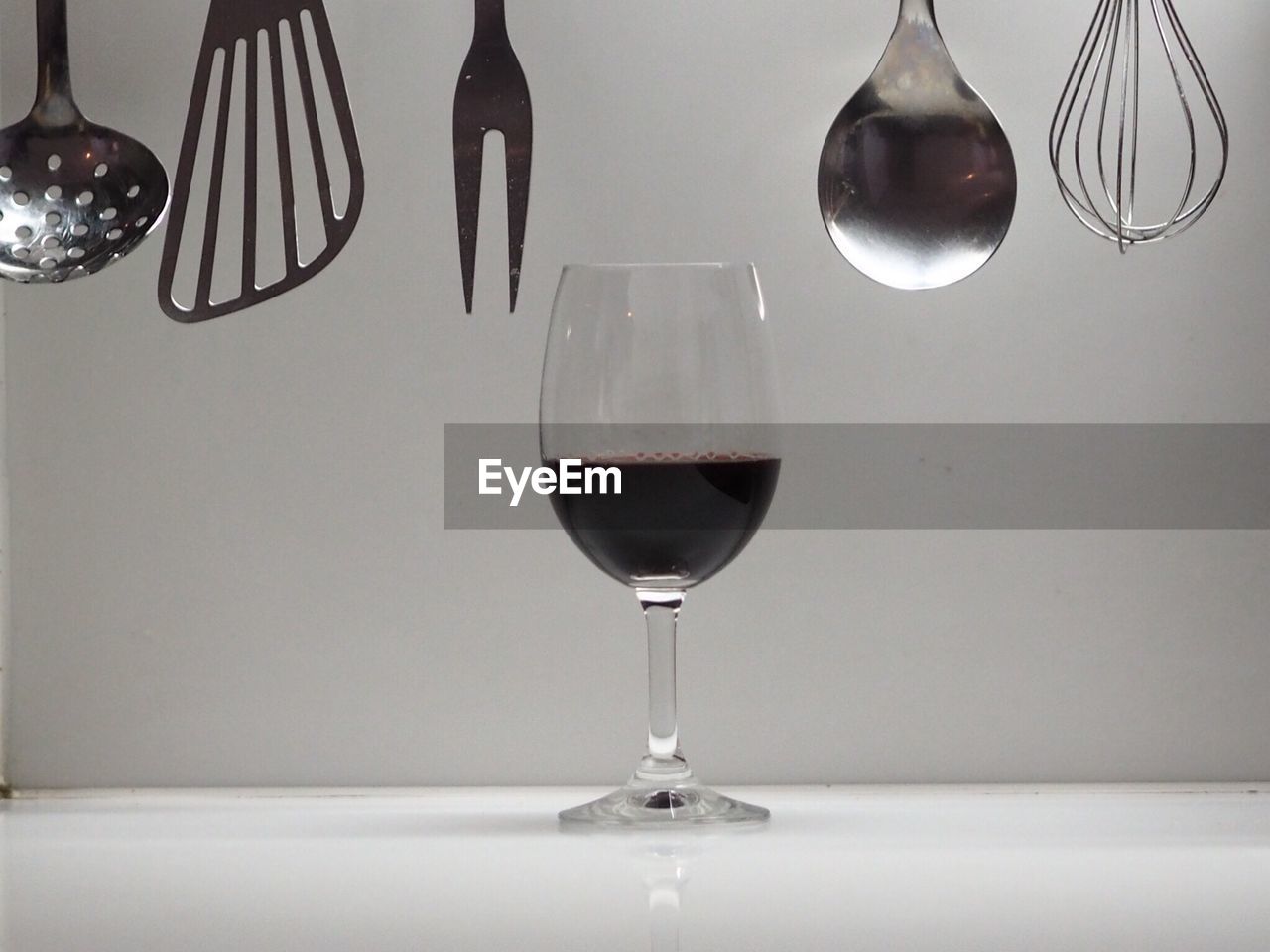 Wineglass with kitchen utensils