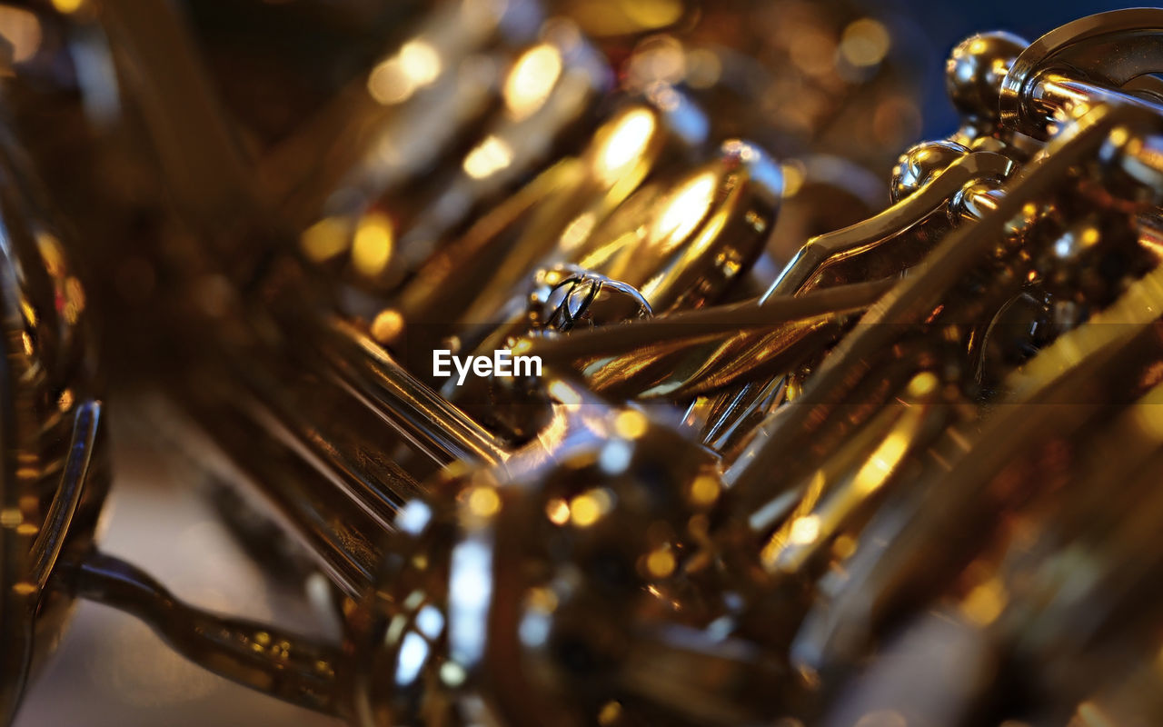 Close-up of a saxophone in front of a christmas tree.