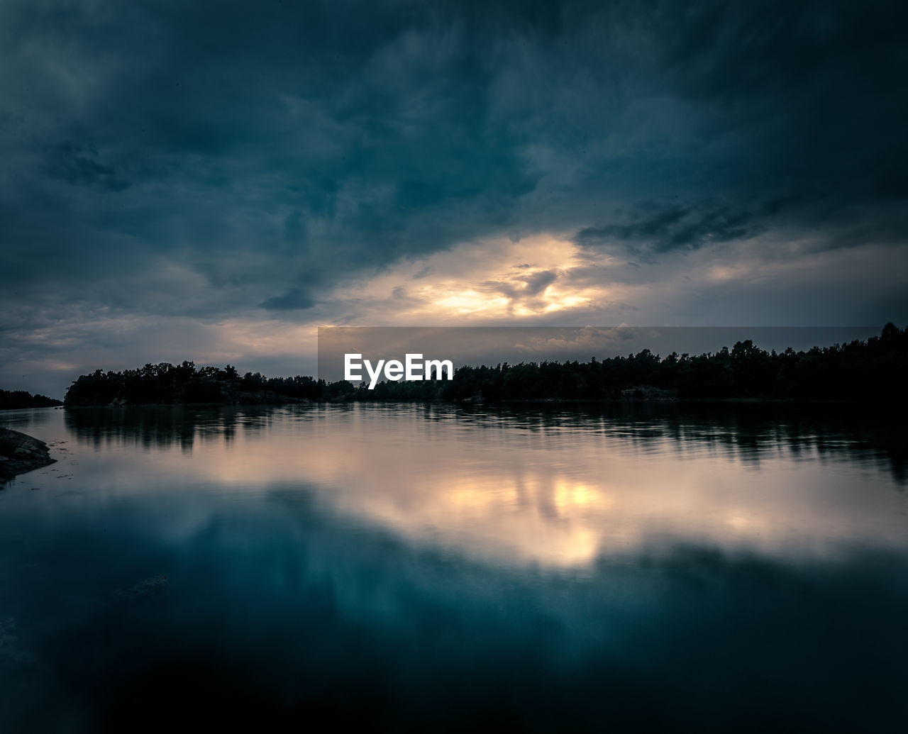 Scenic view of lake against sky during sunset