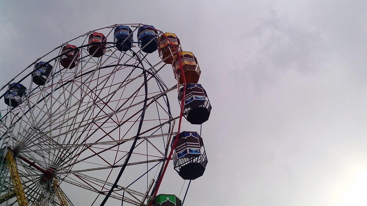 LOW ANGLE VIEW OF FERRIS WHEEL AT NIGHT
