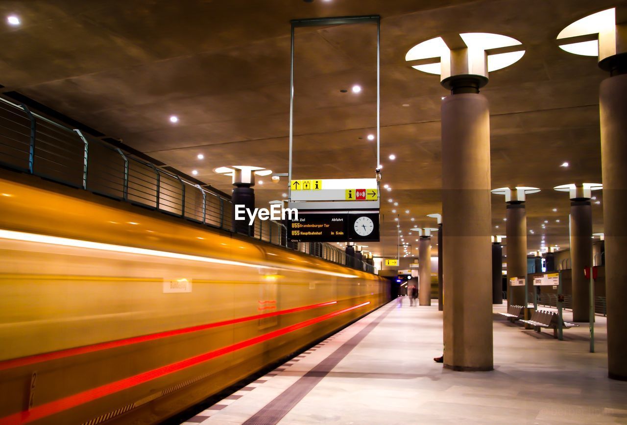 TRAIN ON RAILROAD STATION PLATFORM AT NIGHT