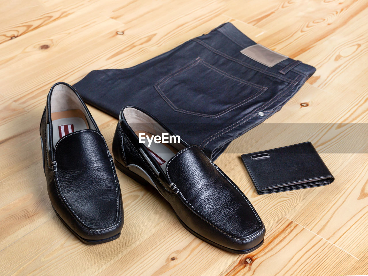 HIGH ANGLE VIEW OF SHOES ON WOODEN TABLE