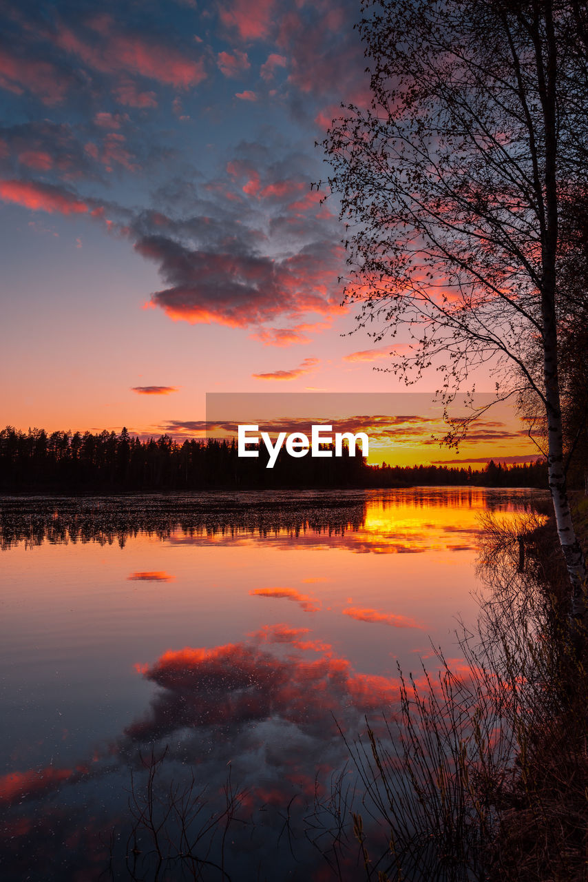 Scenic view of river against romantic sky at sunset