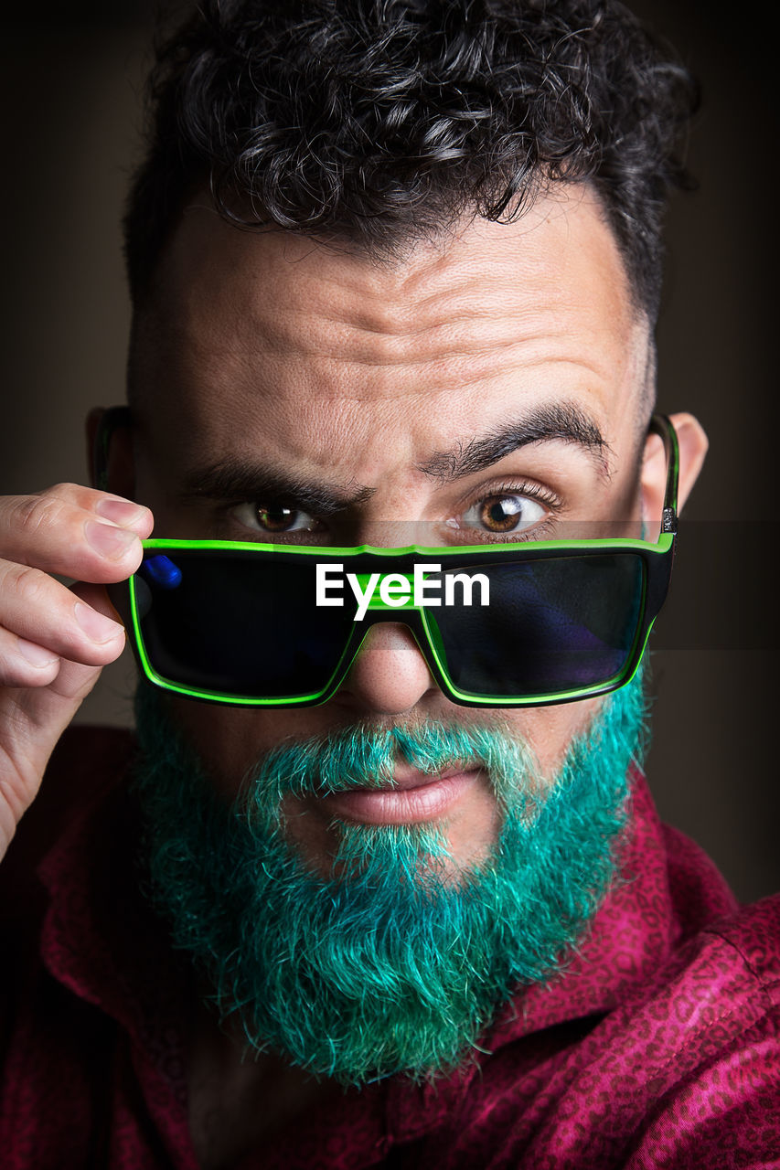 Close-up portrait of bearded man wearing sunglasses