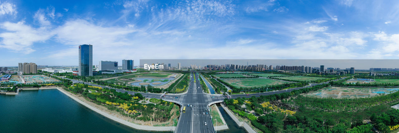 High angle view of road by buildings against sky