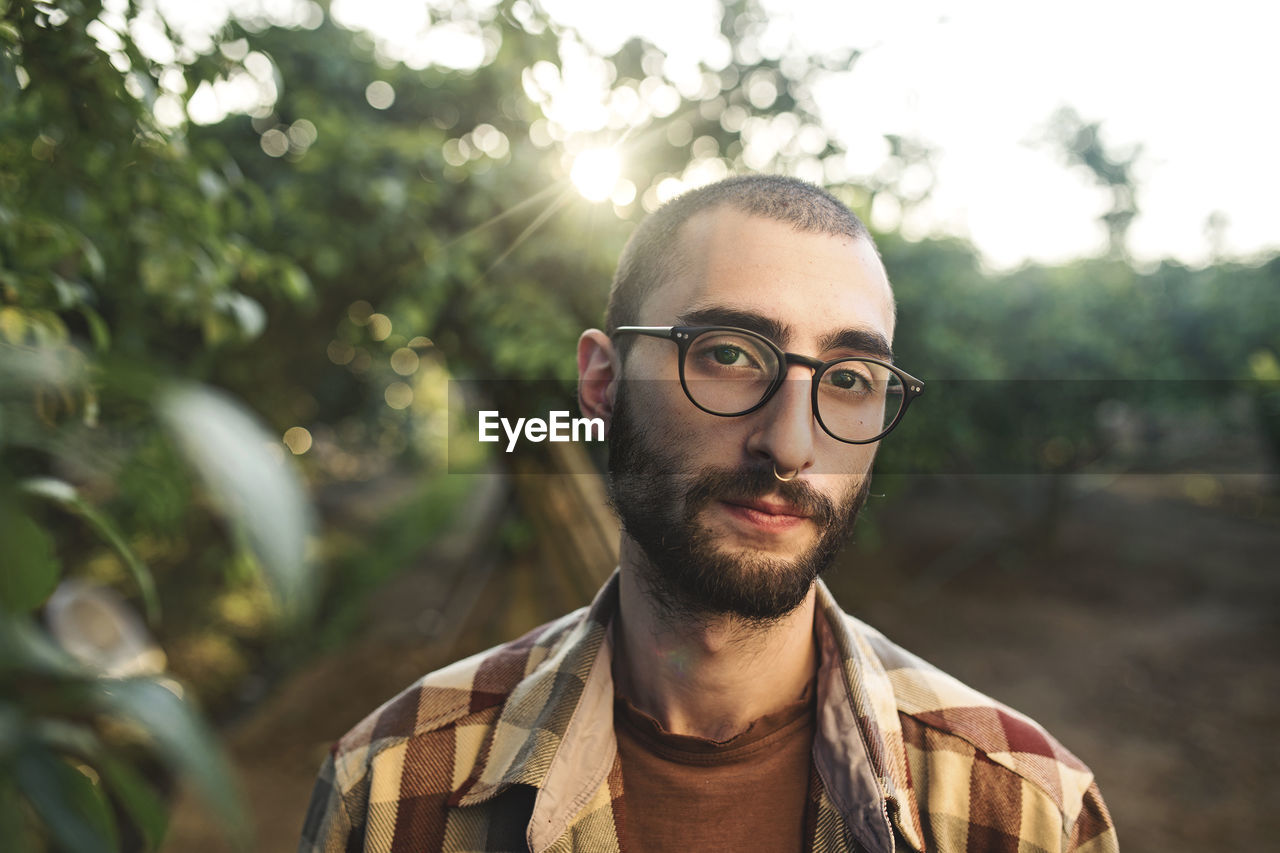 PORTRAIT OF YOUNG MAN WITH EYEGLASSES