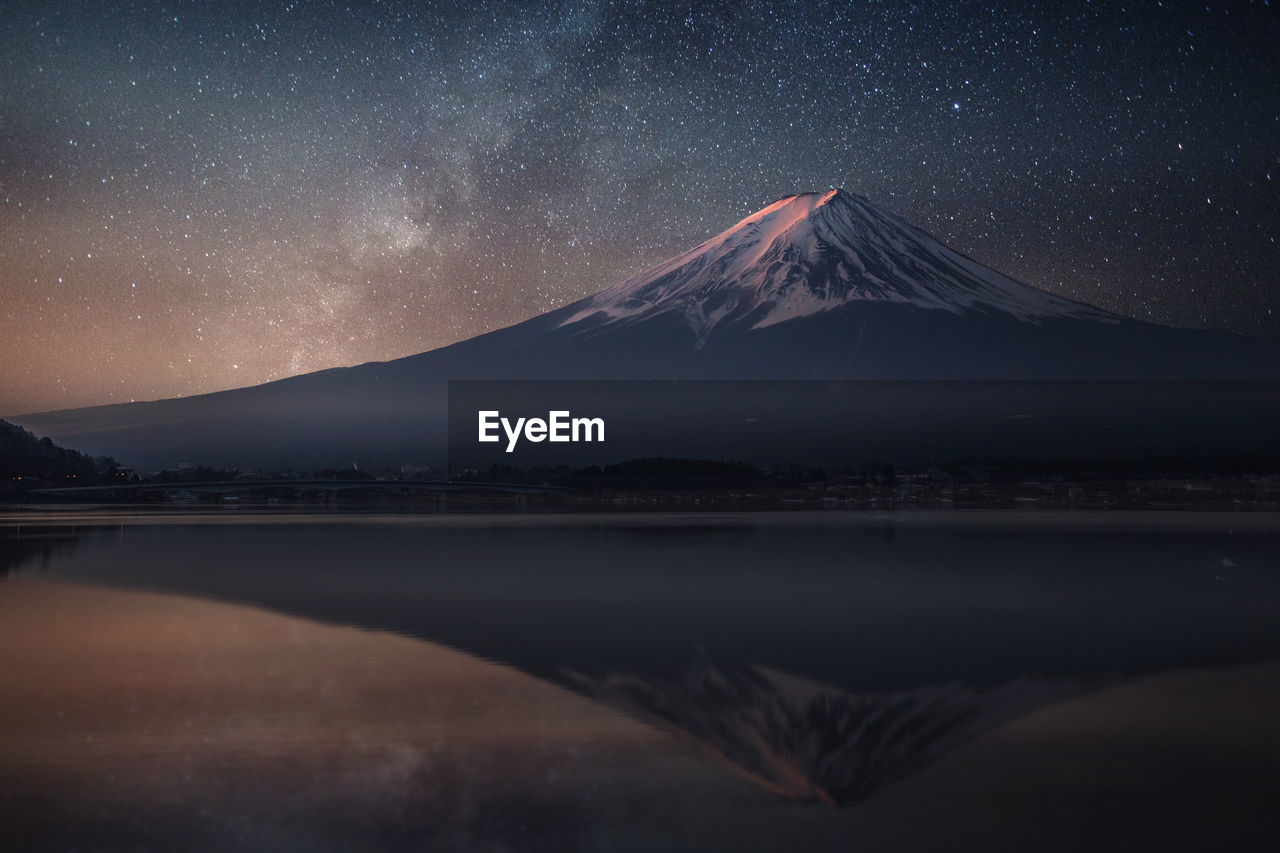 Scenic view of majestic mountain against sky at night