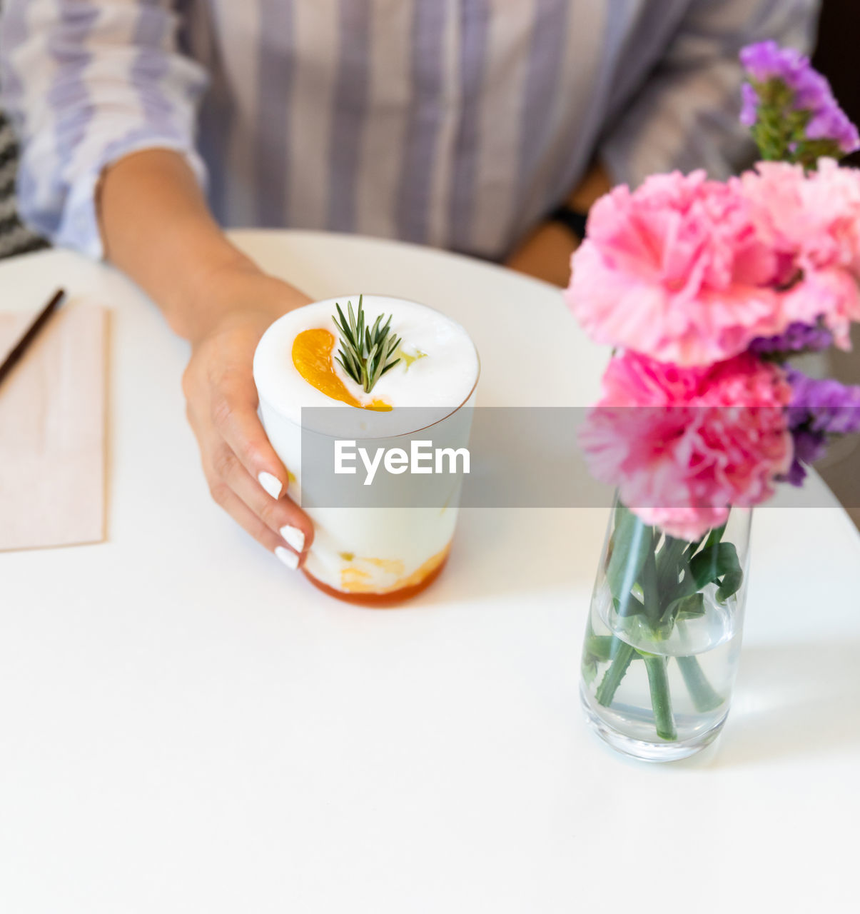 midsection of woman having breakfast on table