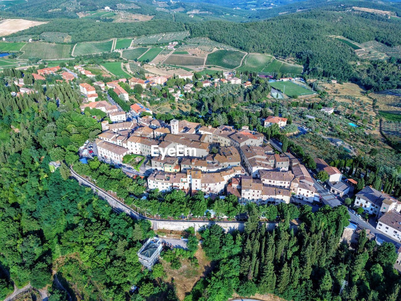 HIGH ANGLE VIEW OF RESIDENTIAL DISTRICT AND TREES IN CITY