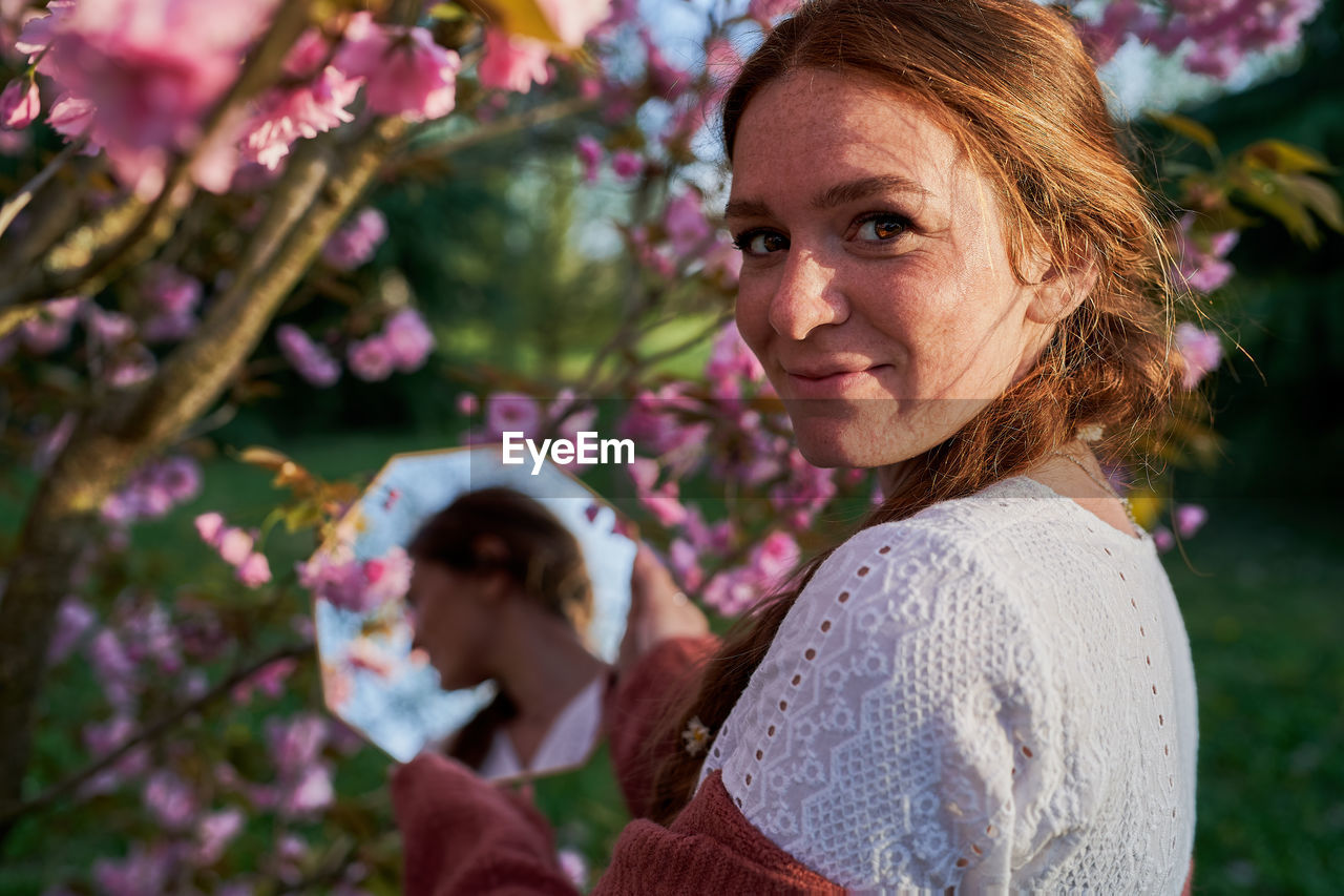 Portrait of smiling woman against plants