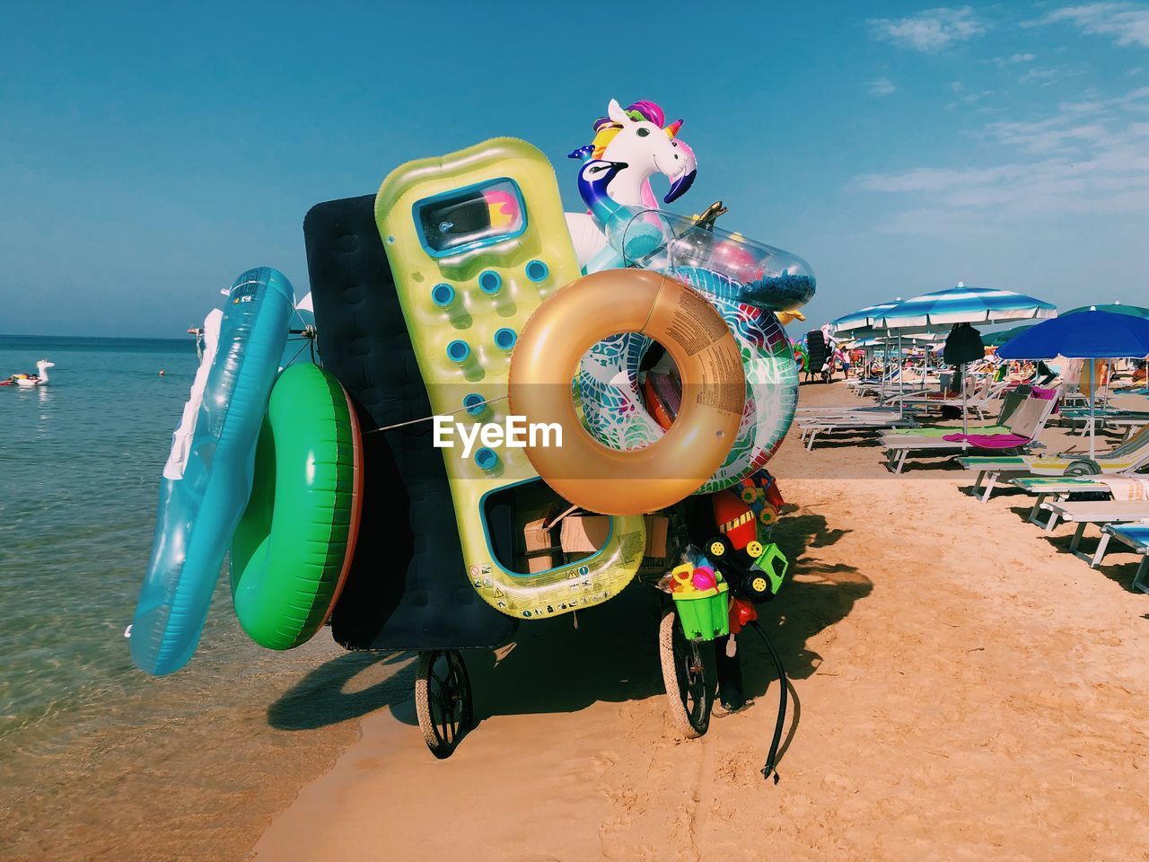 High angle view of inflatables for sale on the beach