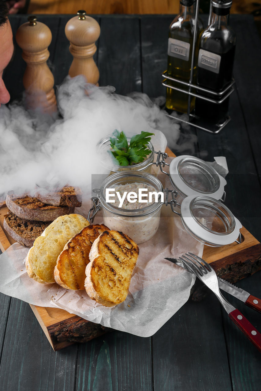 HIGH ANGLE VIEW OF ICE CREAM ON WOODEN TABLE