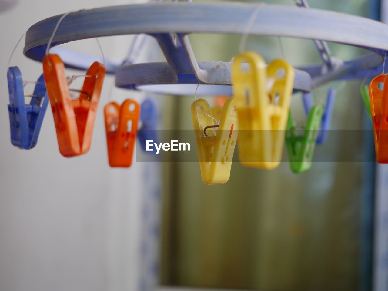 Close-up of colorful clothespins hanging at home