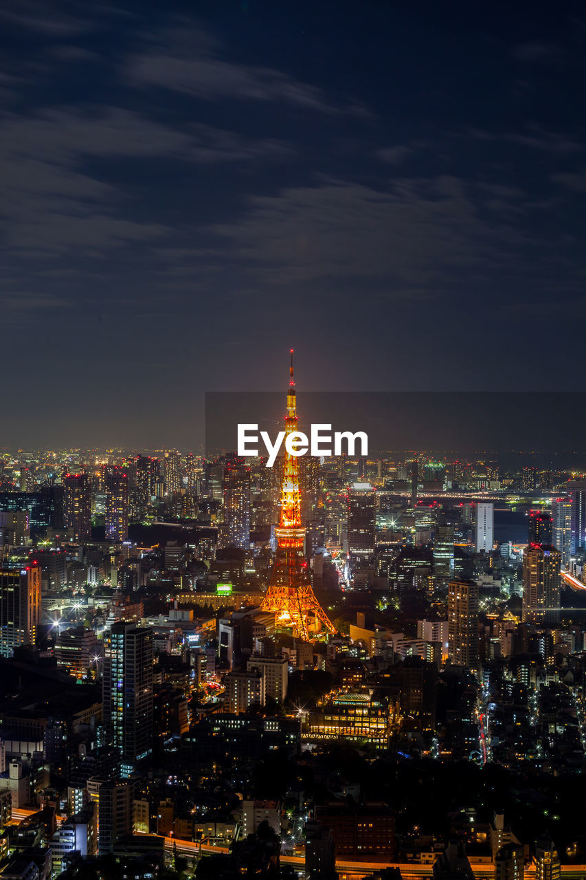 Illuminated cityscape against sky at night