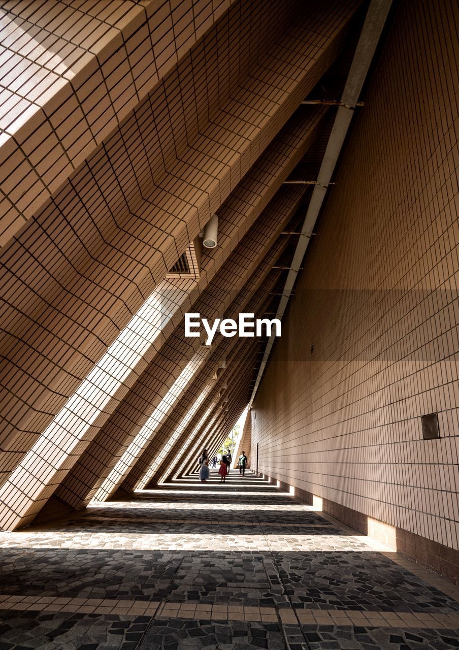 People walking in corridor of building