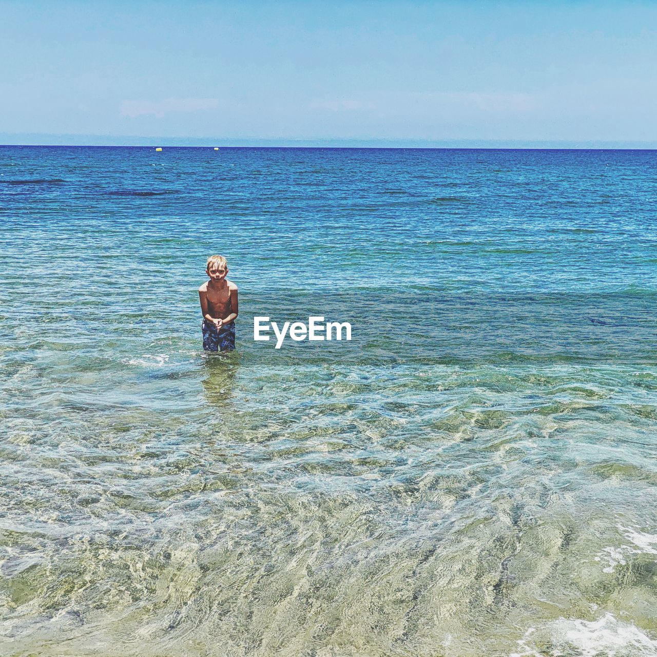 rear view of man swimming in sea against sky