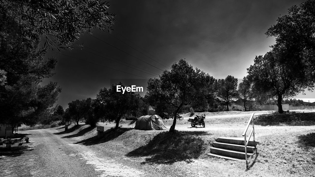 PEOPLE SITTING ON BENCH IN PARK DURING AUTUMN