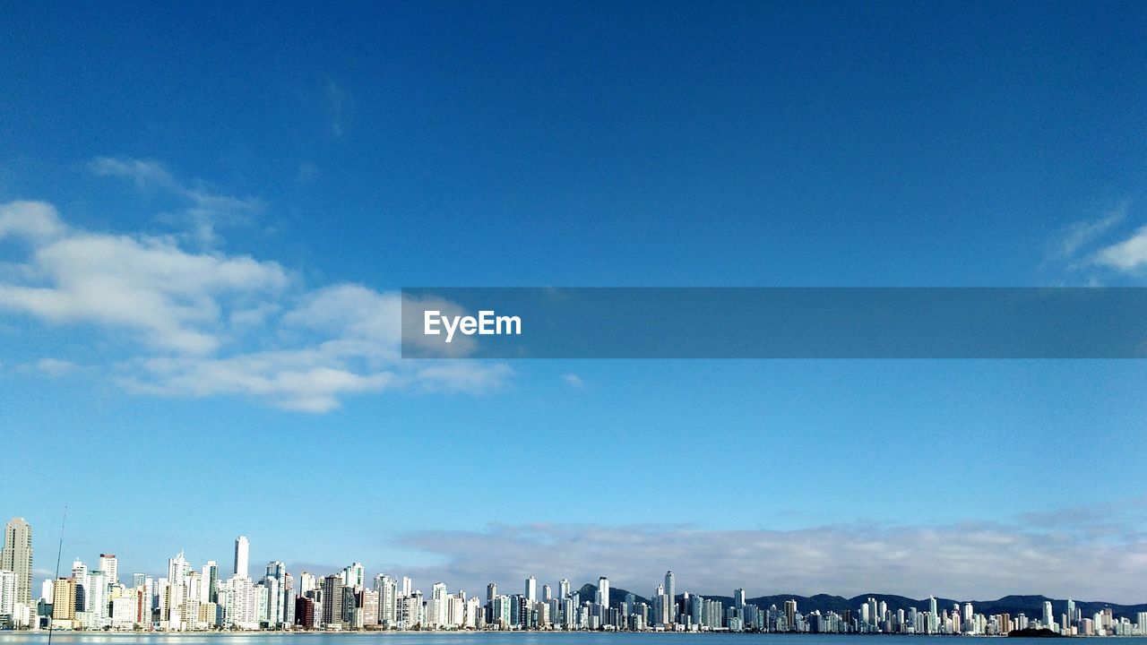 VIEW OF BUILDINGS IN CITY AGAINST BLUE SKY