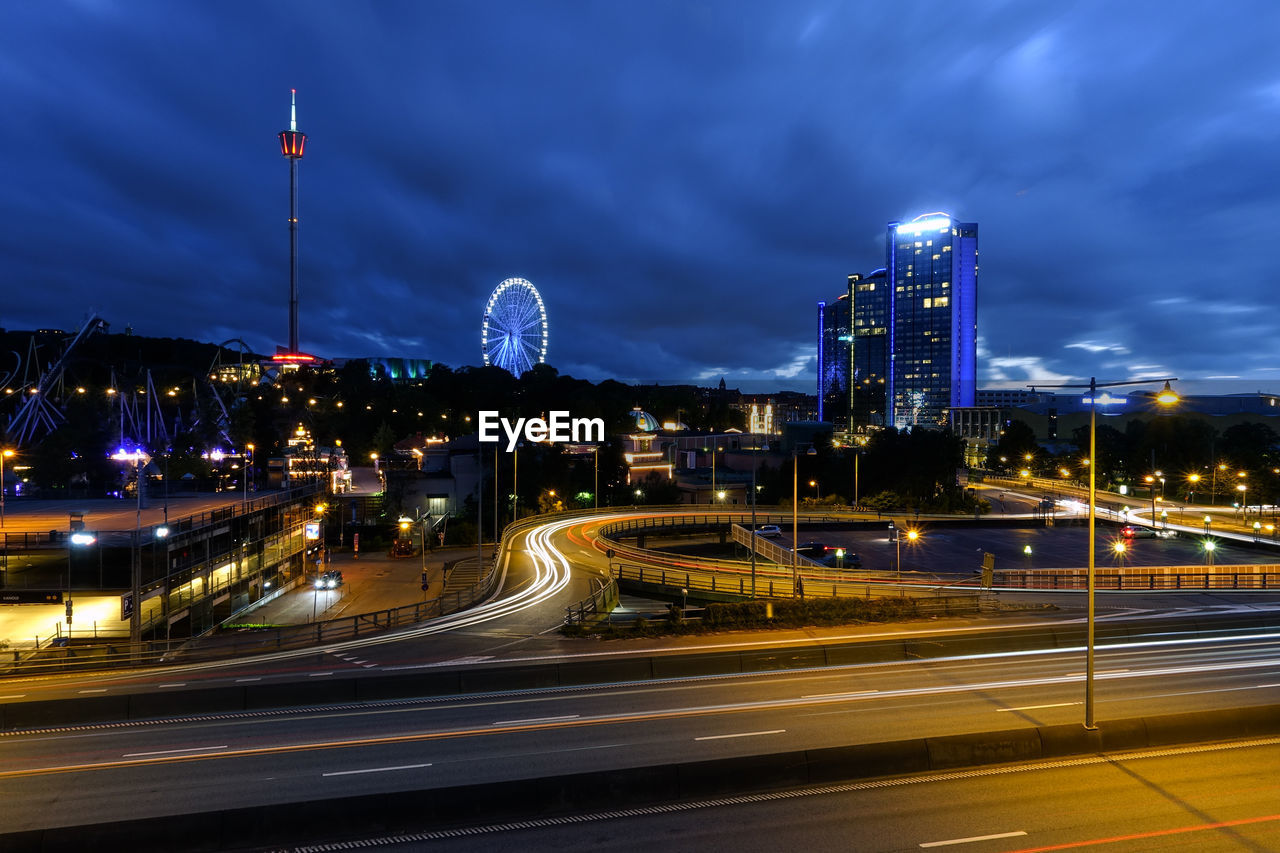 ILLUMINATED CITYSCAPE AGAINST SKY AT NIGHT