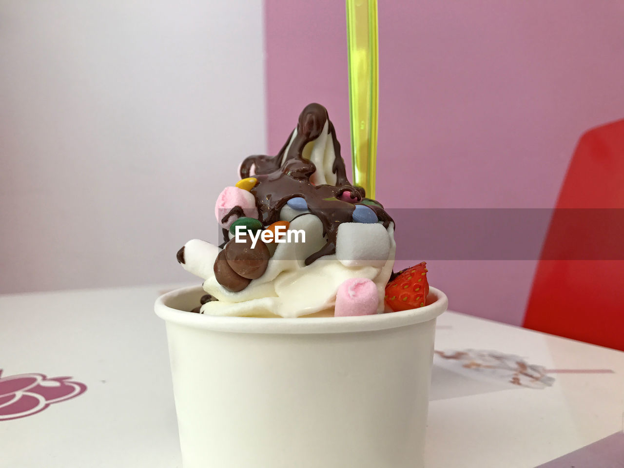 CLOSE-UP OF ICE CREAM IN CUP ON TABLE