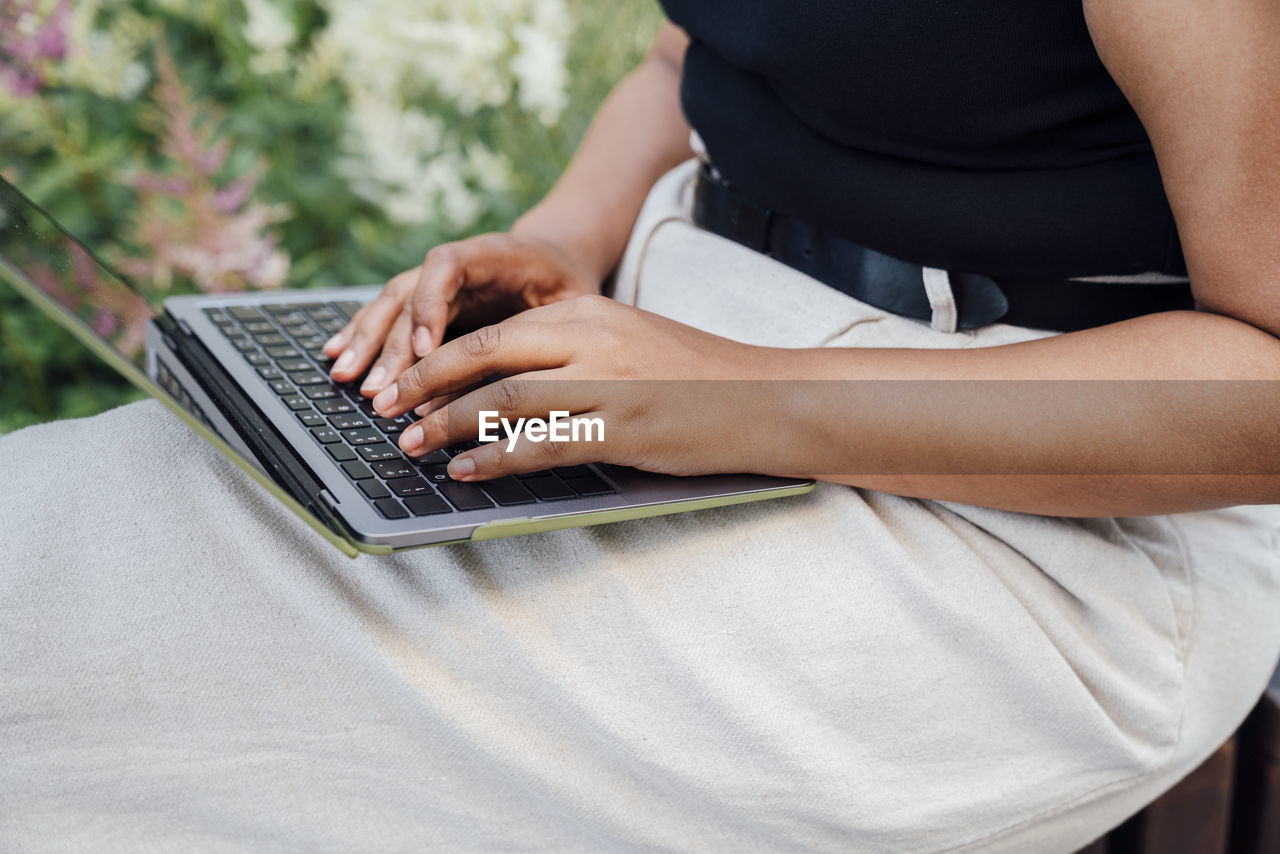 Hands of businesswoman typing on laptop