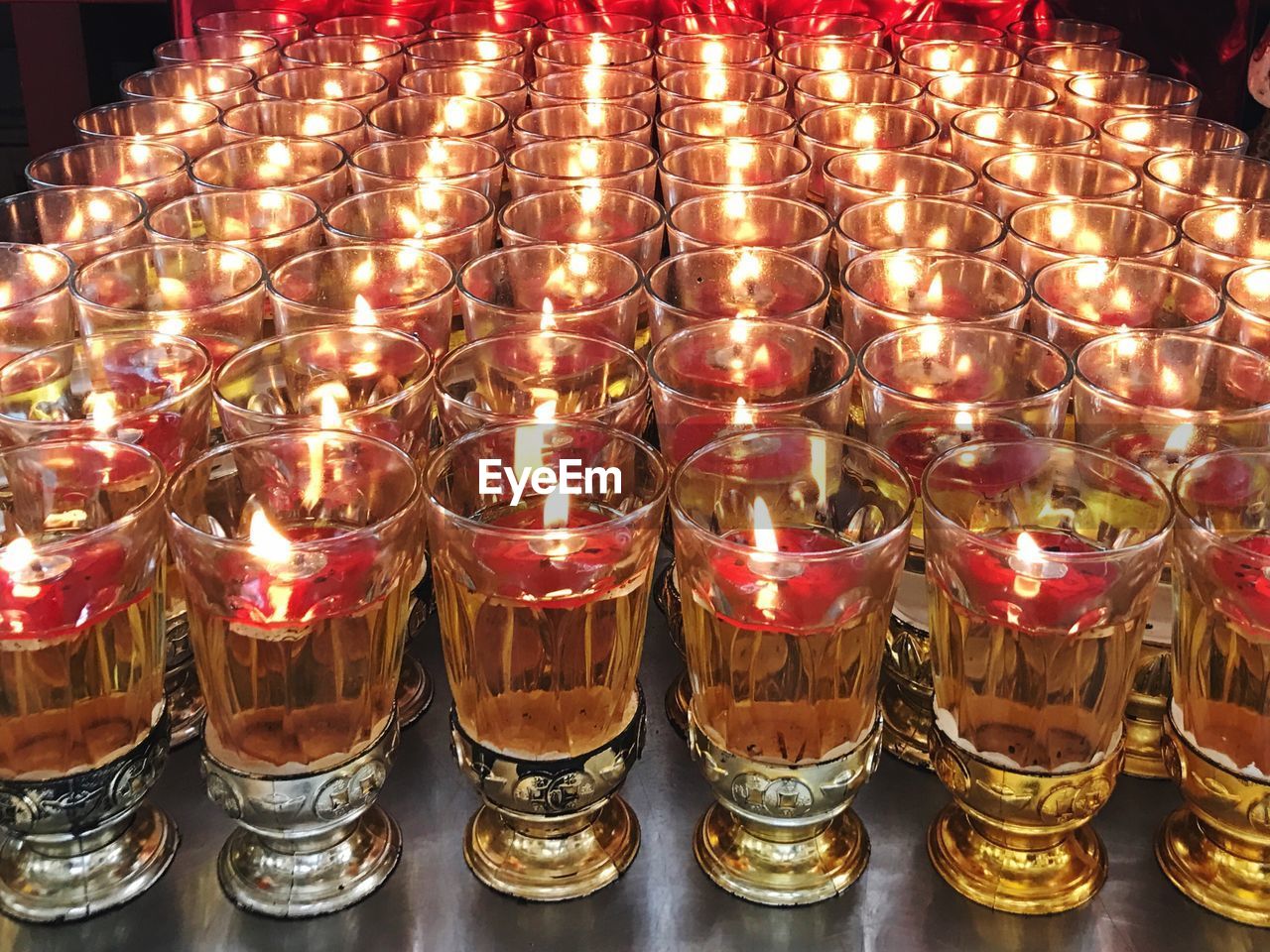 High angle view of lit tea light candles on table