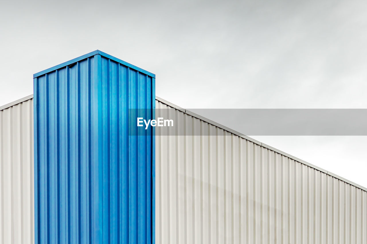 Low angle view of cargo container against sky