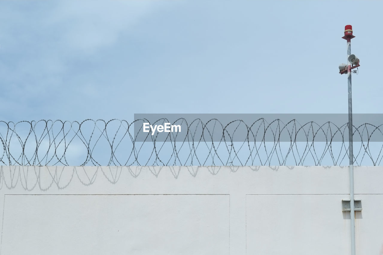 VIEW OF BARBED WIRE AGAINST SKY