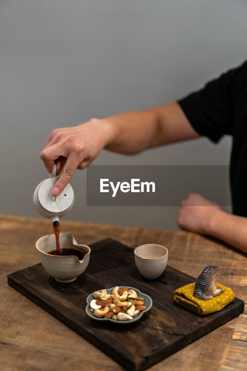 cropped hand of person preparing gingerbread cookies on table