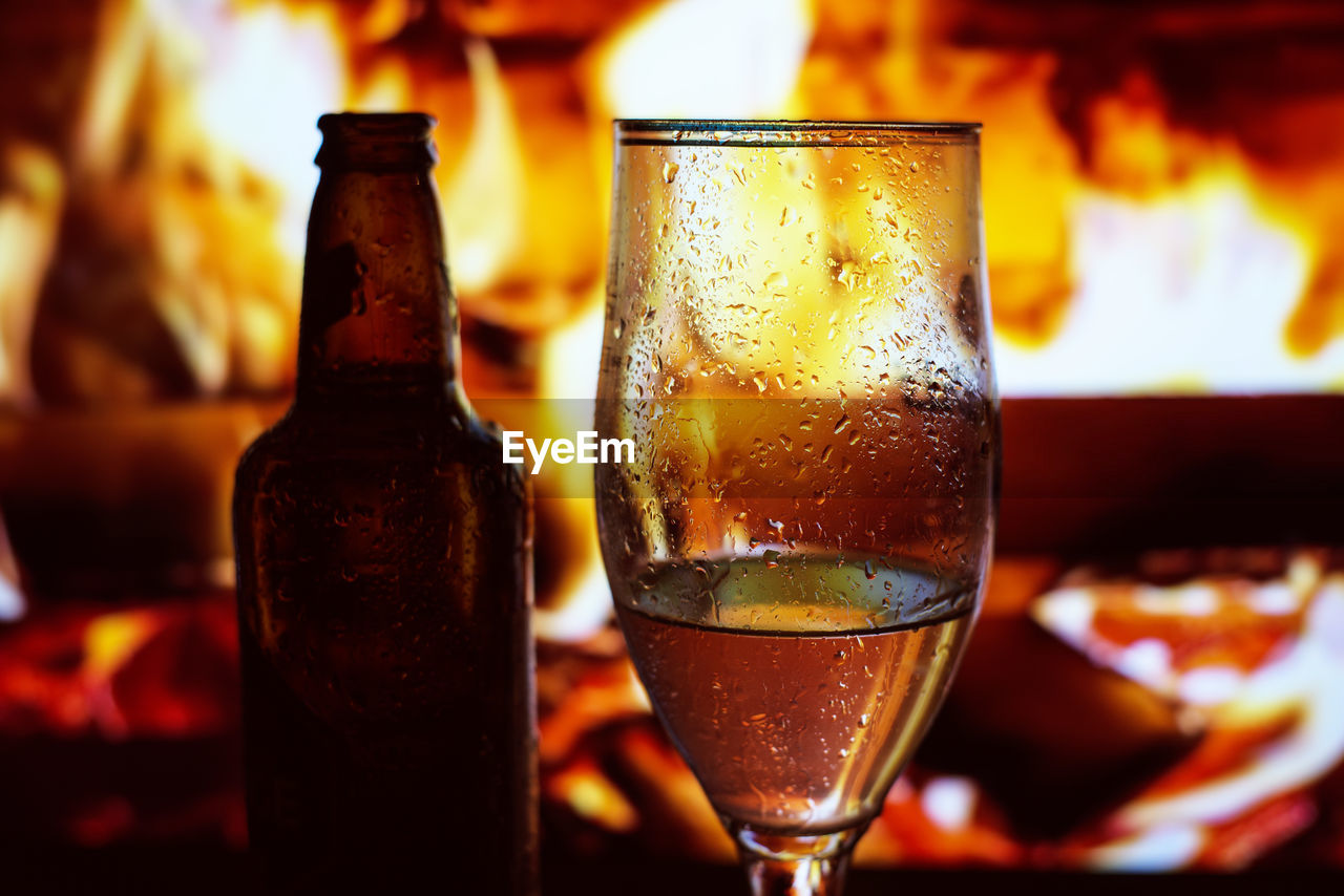 CLOSE-UP OF BEER IN GLASS ON WOODEN TABLE