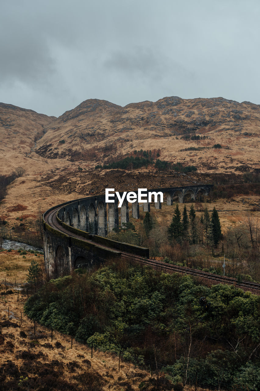 Glenfinnan viaduct over mountains against sky