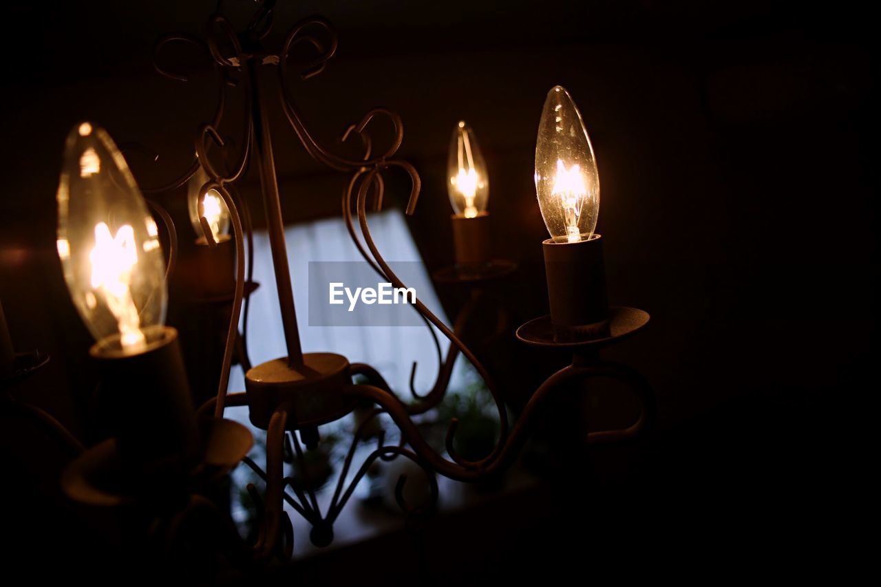 Close-up of illuminated decorations in darkroom
